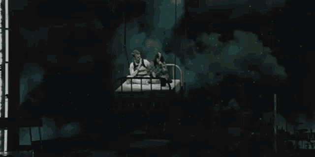 a man and a woman are sitting on a bed in a bucket .