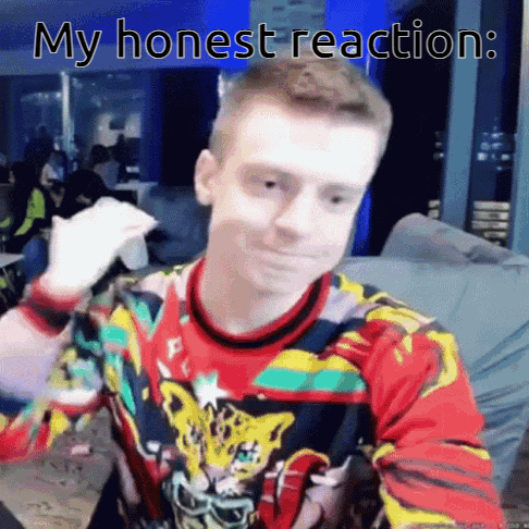 a man in a colorful sweater is sitting at a table with a cup of coffee .