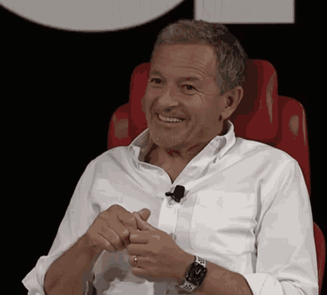 a man in a white shirt with a watch on his wrist