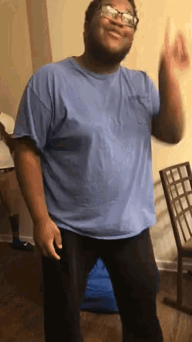 a man in a blue shirt and black pants is dancing
