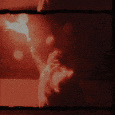 a silhouette of a person holding a torch in the dark