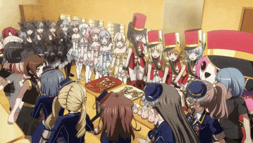 a group of anime girls are gathered around a table with a tray of food