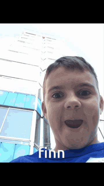 a young boy is wearing a blue shirt that says finn on it
