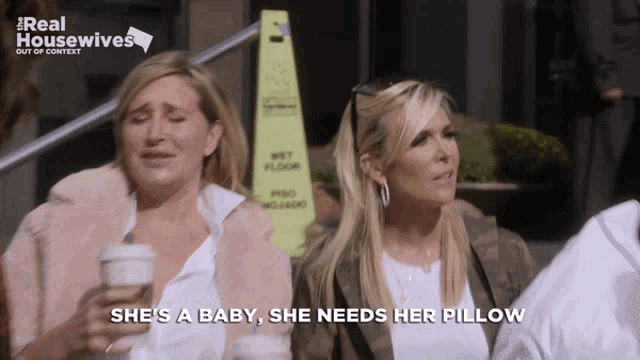 a woman says she 's a baby she needs her pillow while holding a cup of coffee
