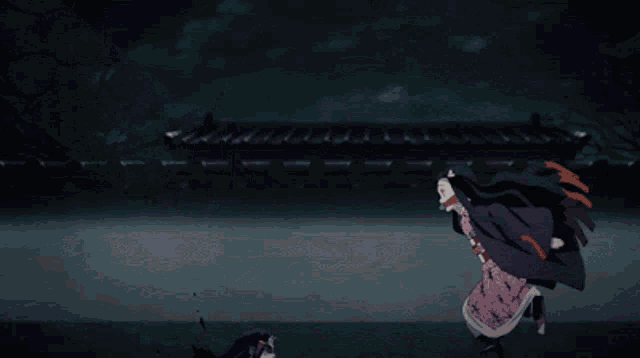 a girl in a pink dress is jumping in the air in a dark room