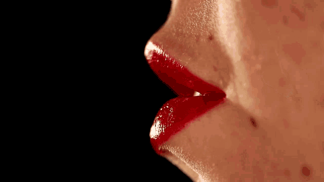 a close up of a woman 's face with red lipstick and the word moazz in red