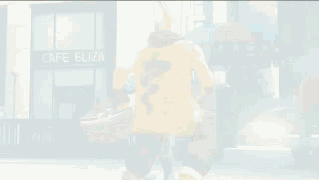 a cartoon character stands in front of a cafe eliza