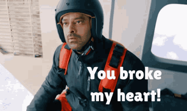 a man wearing a helmet and a jacket says you broke my heart