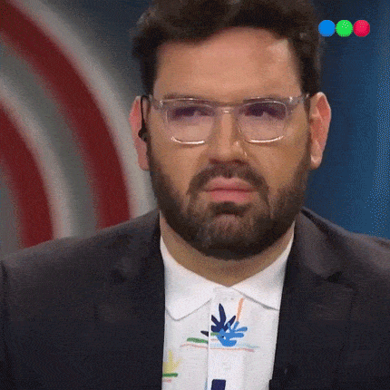 a man with a beard is wearing glasses and a suit