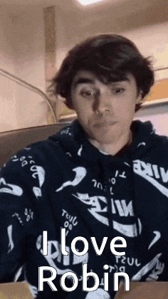 a young man wearing a hoodie with the words i love robin on it
