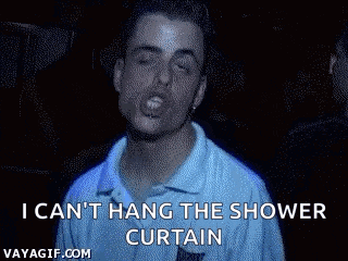 a man in a blue shirt is singing and says i can 't hang the shower curtain