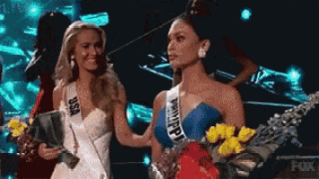 two women are standing next to each other and one has a sash that says usa