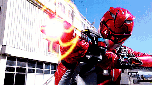 a person in a red helmet holding a gun