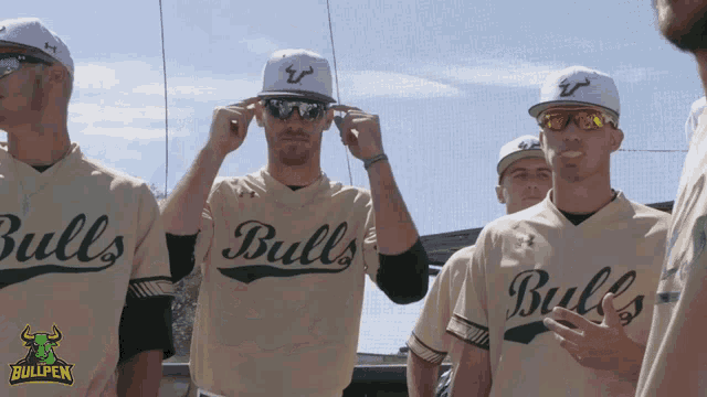 a group of men wearing bulls jerseys are standing together