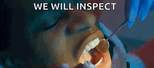 a dentist is examining a patient 's teeth with a mirror .