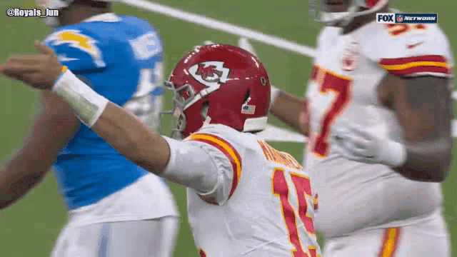 a football player wearing a red helmet with the kc logo on it