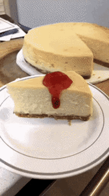 a slice of cheesecake with a strawberry sauce on top