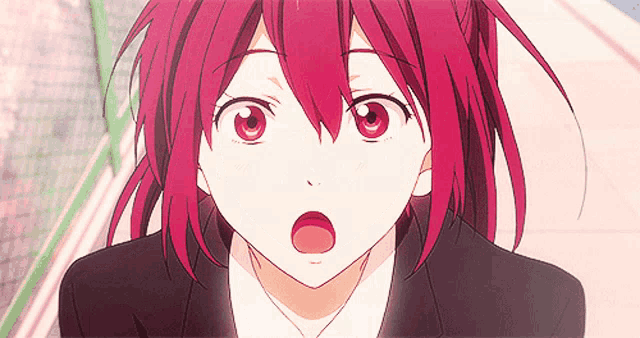 a close up of a person with red hair and a surprised look on their face
