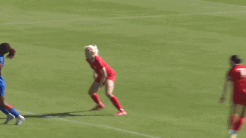 a soccer goalie is diving to catch a ball in front of a sign that says asport