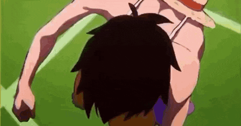 a cartoon character is standing on a green field with a fist in the air .