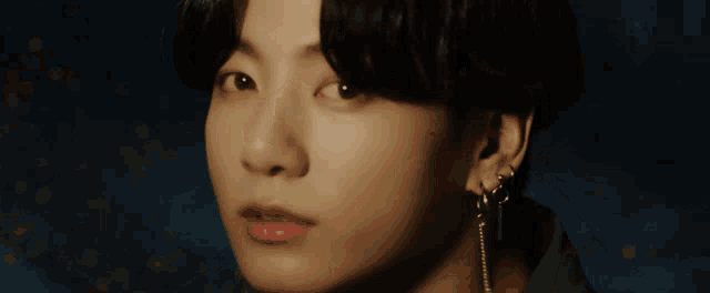 a close up of a person 's face with dark hair