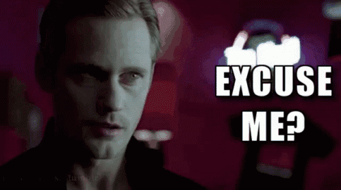 a man is standing in front of a neon sign that says excuse me