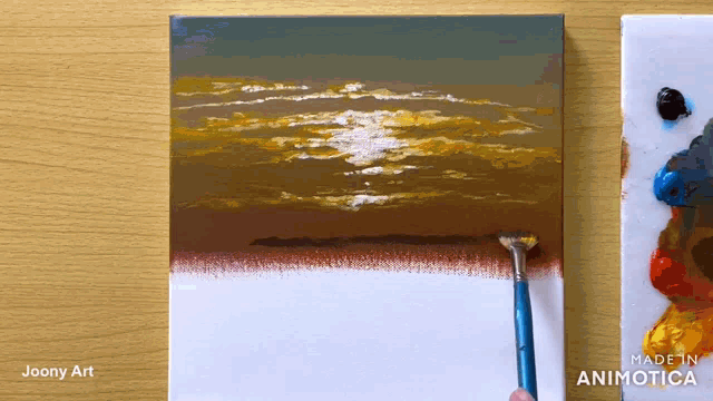 a painting of a sunset is being painted by joony art