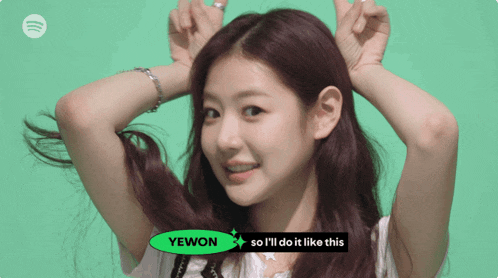a girl with a green sign that says yewon
