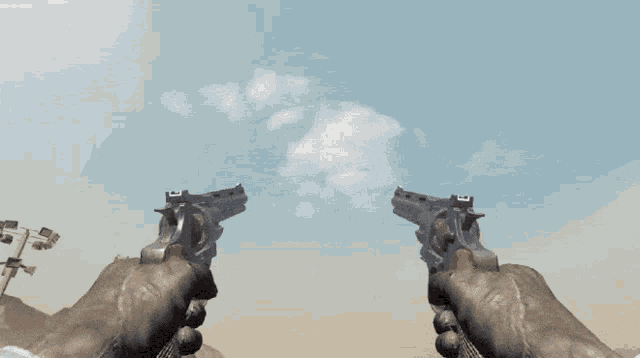 a person holding two revolvers in their hands with a blue sky in the background
