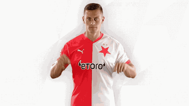 a man wearing a red and white jersey that says etoro on it