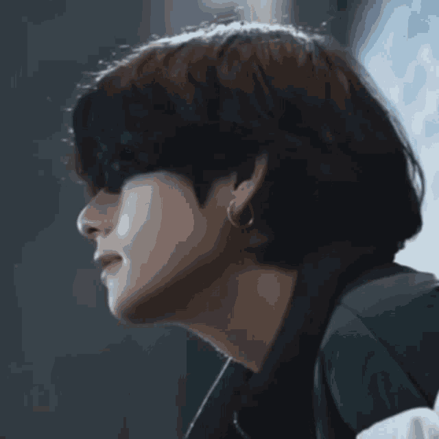 a close up of a person 's face with a dark hair color