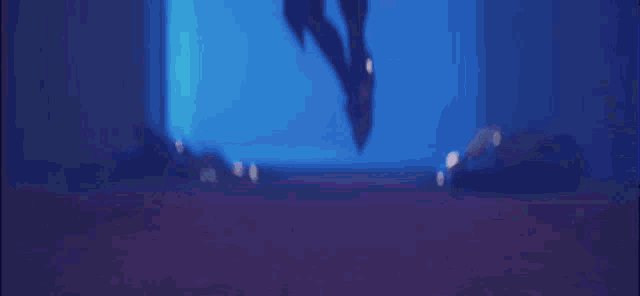 a woman in a purple and pink costume is standing in a dark room in a video game .