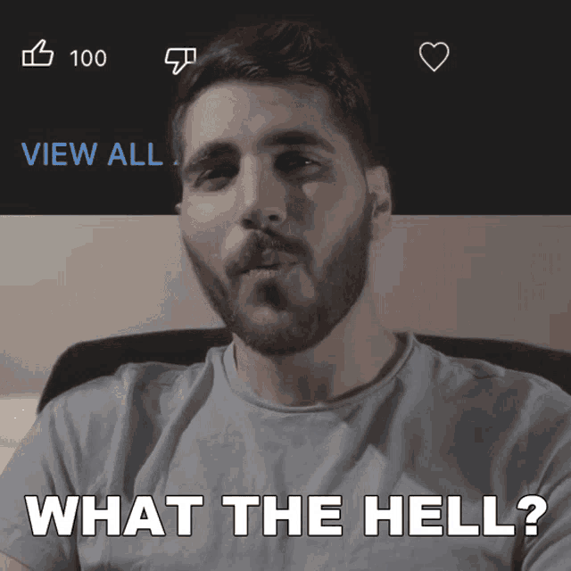 a man with a beard says " what the hell " in front of a screen that says view all