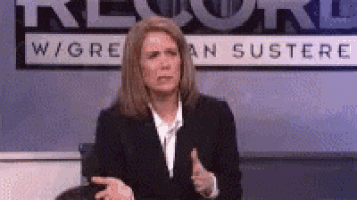 a woman in a suit is sitting in front of a sign that says record
