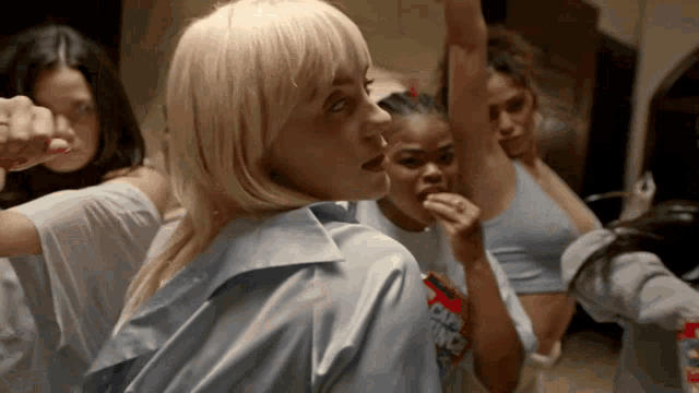 a group of women are dancing and one of them is wearing a shirt that says ' i 'm not a fan '