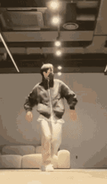 a person wearing a mask is jumping in the air in a room