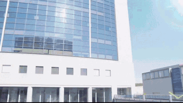 a large white building with a lot of windows and a sign that says ' a ' on it