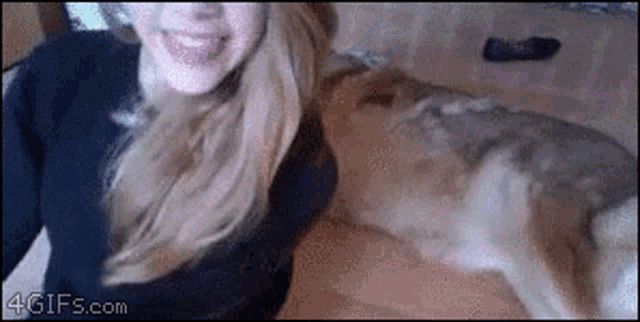 a gif of a woman and a dog with 4gifs.com written on the bottom right