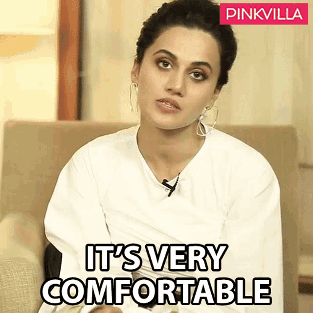 a woman sitting in a chair with the words it 's very comfortable