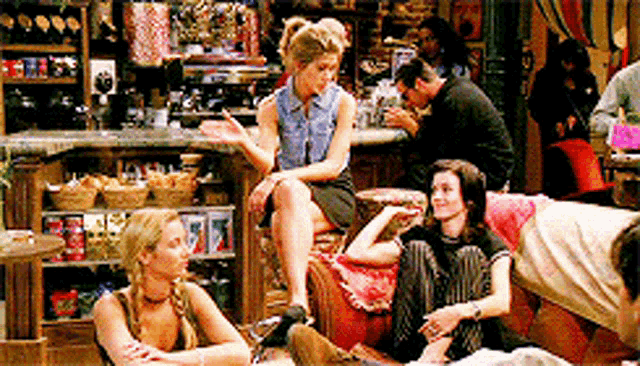 a group of people are sitting on a couch in a restaurant