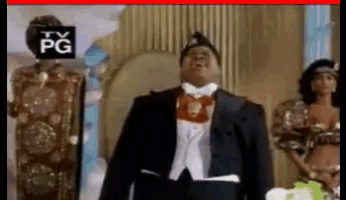 a man in a tuxedo and bow tie is standing in front of a tv pg logo