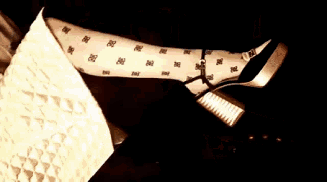 a woman is laying on a couch with her legs crossed and wearing polka dot tights .