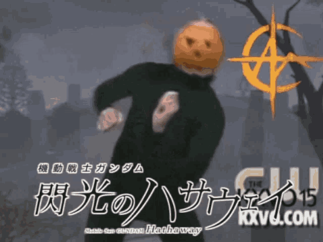 a man with a pumpkin on his head stands in front of a sign that says kxv6.com