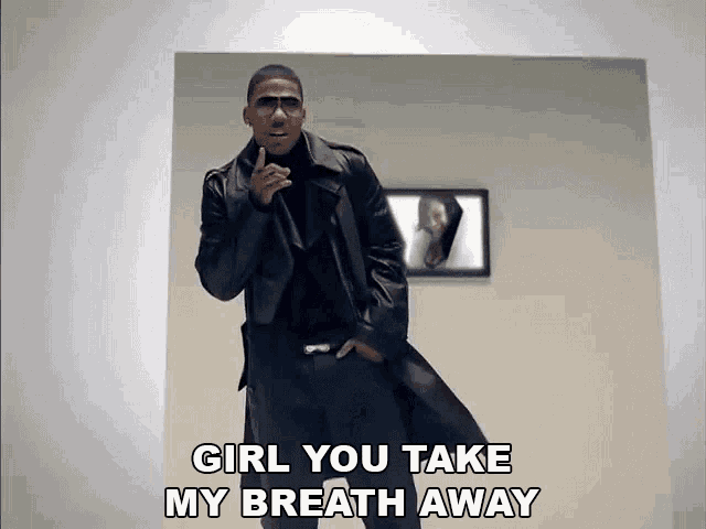 a man in a trench coat is singing a song that says girl you take my breath away
