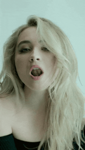 a close up of a woman 's mouth with her tongue sticking out