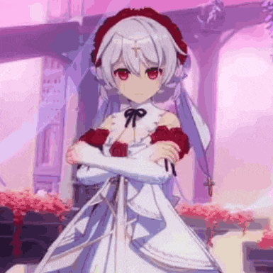 a girl in a white dress with red roses is standing with her arms crossed in front of a building .