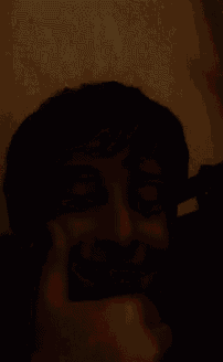 a young boy is making a funny face and giving a thumbs up