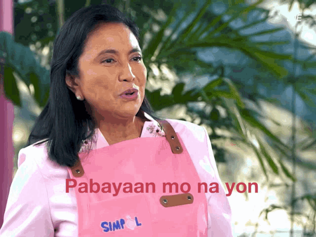 a woman wearing a pink apron that says simp l on it