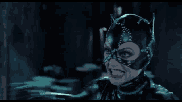 a woman in a catwoman costume with red lipstick on her face
