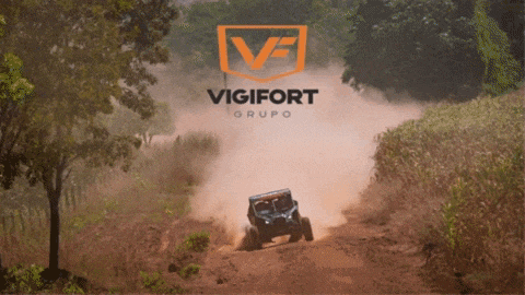 a blue atv is driving down a dirt road with the logo for vigilort grupo